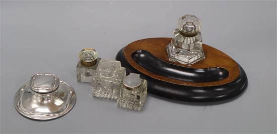 A silver capstan inkwell and four other inkwells (5)